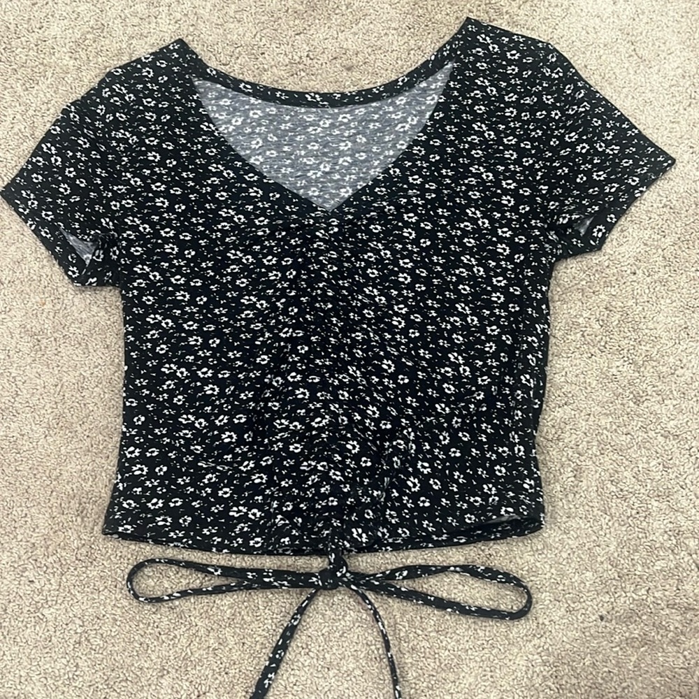 Black crop top with white flowers. Size XS. 95% polyester, 5% elastane